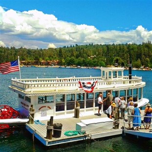 Orange DayTripper flag in front of the Arrowhead Queen boat